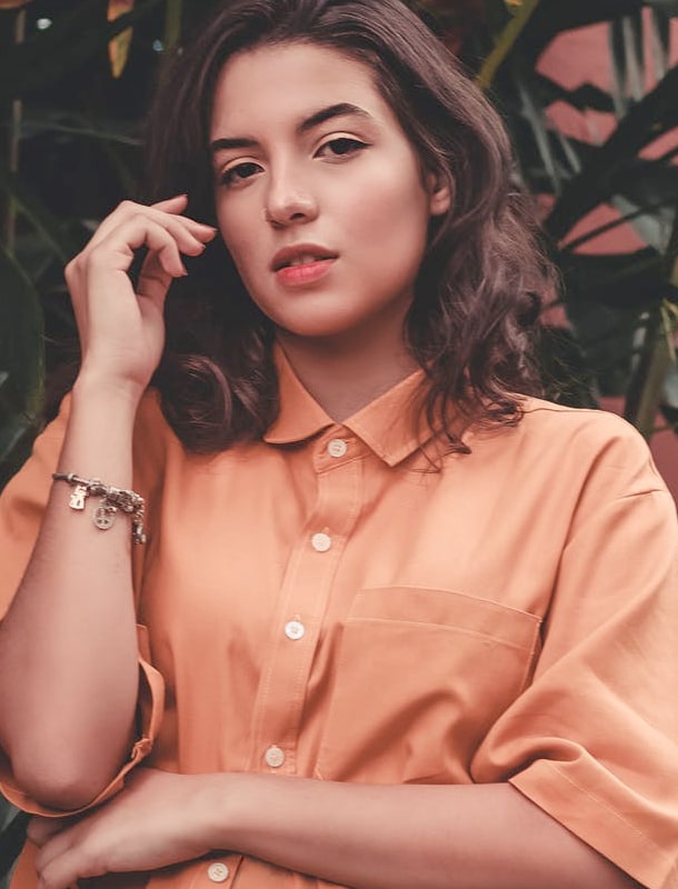 clothing model wearing peach top